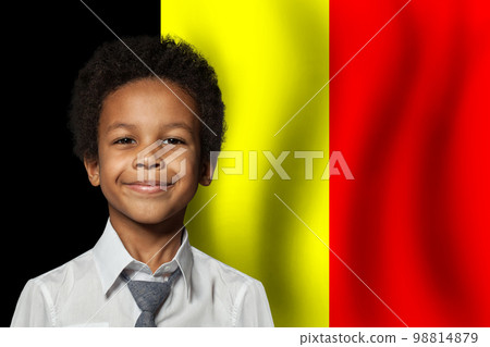 Belgium kid boy on flag of Belgium background. Education and childhood concept Belgium kid boy on flag of Belgium background. Education and childhood concept 98814879