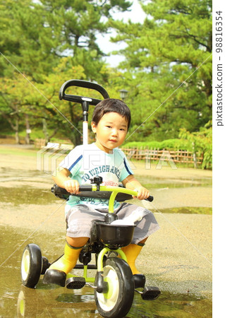 child riding a tricycle child riding a tricycle 98816354