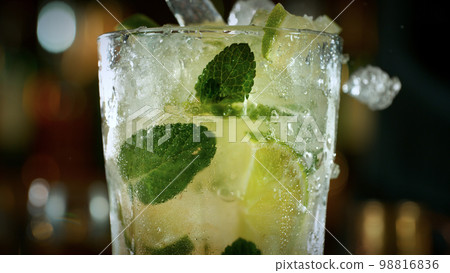 Mojito cocktail on the bar, dark toned background Mojito cocktail on the bar, dark toned background 98816836