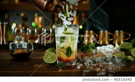 Mojito cocktail on the bar, dark toned background Mojito cocktail on the bar, dark toned background 98816840