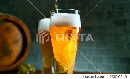 Freshly brewed beer in a pint on old wooden table, close-up Freshly brewed beer in a pint on old wooden table, close-up 98816849