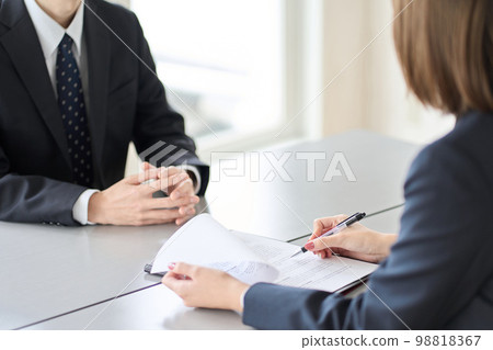 Hands of a woman conducting a business interview Hands of a woman conducting a business interview 98818367