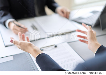 Hand of a business woman giving an explanation at a meeting Hand of a business woman giving an explanation at a meeting 98818369