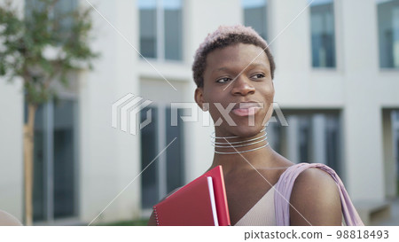 Content queer black man with folder on street Content queer black man with folder on street 98818493