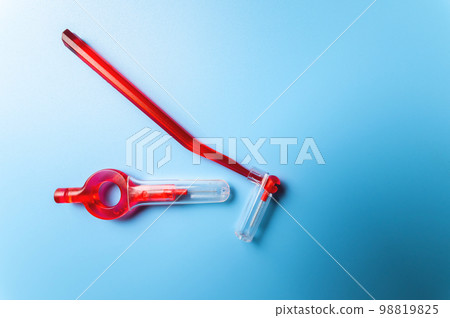 Interdental brush of red color close-up on a blue background, macro shot of orthodontic appliances for dental care 98819825