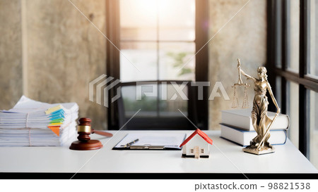 Law office with Judge's hammer book, scales of justice and laptop on lawyer's desk Law office with Judge's hammer book, scales of justice and laptop on lawyer's desk 98821538