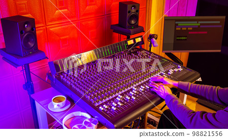 male professional sound engineer, music producer hands working on audio mixing console in home studio male professional sound engineer, music producer hands working on audio mixing console in home studio 98821556