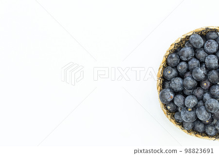 Blueberries in a plate on a white background isolated, top view. 98823691