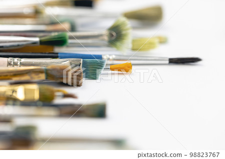 Paint brushes stained with paint, close-up, macro shot. Paint brushes stained with paint, close-up, macro shot. 98823767