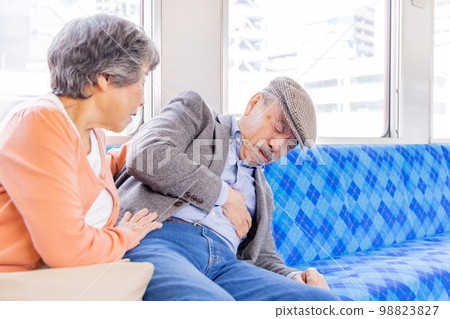 Senior man getting sick on the train 98823827