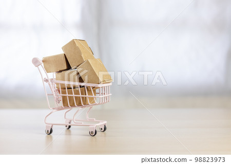 paper box in small shopping cart. home delivery service from supermarket. 98823973