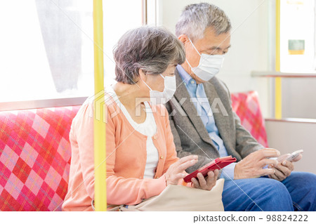 Silver seat Senior men and women sitting in priority seats 98824222