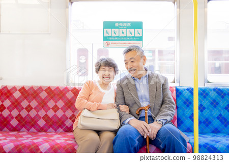 Silver seat Senior couple sitting in priority seats 98824313