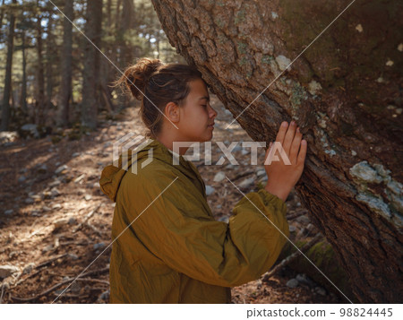 caucasian woman enjoys being in nature, 98824445