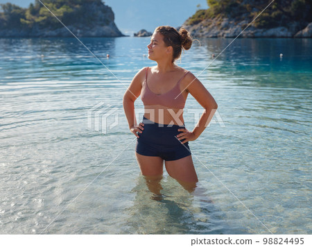 Cheerful woman enjoying the beach 98824495