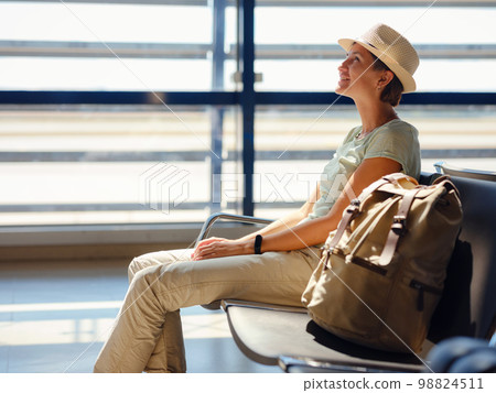 woman at airport waiting for departure woman at airport waiting for departure 98824511