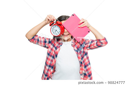 funny school girl with alarm clock on background. photo of school girl with alarm clock and homework 98824777