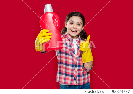 photo of girl household showing detergent. girl household with detergent isolated on red 98824787