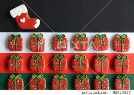 Christmas handmade gingerbread cookies covered with multi-colored icing. Christmas handmade gingerbread cookies covered with multi-colored icing. 98824827