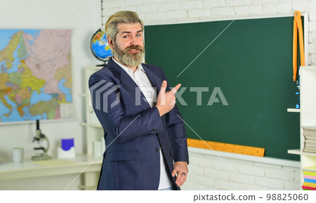 businessman in suit at blackboard. back to school. business school coach. successful in study. get knowledge on lesson. man teacher with dyed beard. bearded man pointing finger businessman in suit at blackboard. back to school. business school coach. successful in study. get knowledge on lesson. man teacher with dyed beard. bearded man pointing finger 98825060