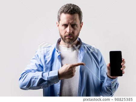 man pointing finger on phone app. photo of man showing phone app. man showing phone app 98825385