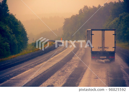 heavy-duty truck on a wet road 98825592