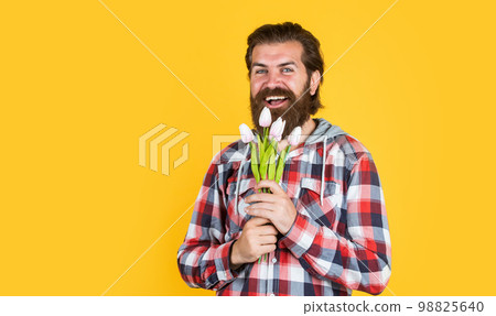 male hipster with fashionable groomed hair and beard hold tulip flowers, fathers day male hipster with fashionable groomed hair and beard hold tulip flowers, fathers day 98825640