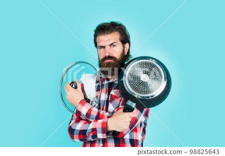 kitchen advertising. Man with saucepan. Man hold new brand pan. Shopping kitchenware. cooking pot in cook man hands in kitchen. food preparation and cuisine. cooking utensils vessels. Party on 98825643