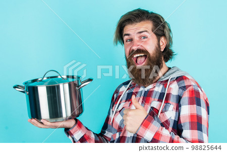 thumb up. professional cook. bearded man hold kitchen pan. brutal hipster cooking with saucepan. housekeep husband cook in pot. mature chef in checkered shirt. prepare meal food at home 98825644