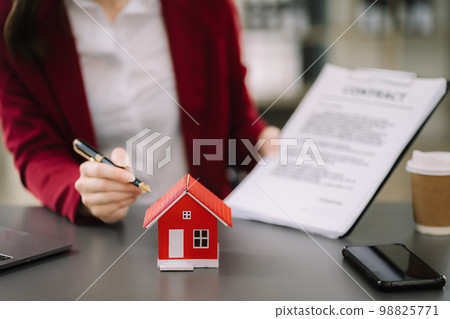 Considering buying a home, investing in real estate. Broker signs a sales agreement. agent, lease agreement, successful deal. Considering buying a home, investing in real estate. Broker signs a sales agreement. agent, lease agreement, successful deal. 98825771