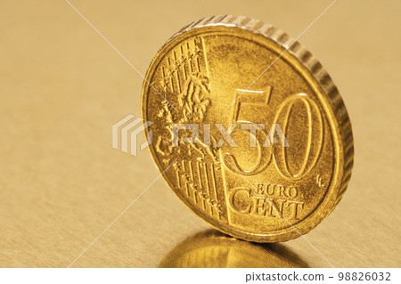 Fifty Euro cent coin on the golden metal background Fifty Euro cent coin on the golden metal background 98826032