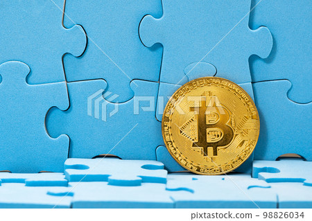 Golden Bitcoin with a blue puzzle Golden Bitcoin with a blue puzzle 98826034