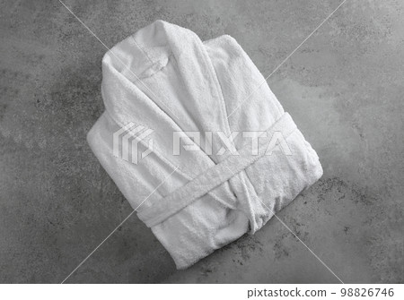 Clean folded bathrobe on grey stone background, top view 98826746
