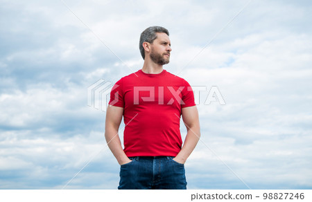 man model in red shirt outdoor on sky background man model in red shirt outdoor on sky background 98827246