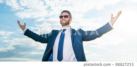 happy successful business man in suit on sky background. successful business man in suit outdoor. happy successful business man in suit on sky background. successful business man in suit outdoor. 98827253