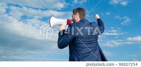 back view of businessman shout in loudspeaker on sky background. advertisement back view of businessman shout in loudspeaker on sky background. advertisement 98827254