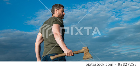 man with axe. woodsman man hold ax. brutal man on sky background man with axe. woodsman man hold ax. brutal man on sky background 98827255
