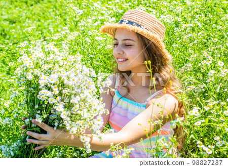 Girl harvesting flowering herbs sunny summer day, eco concept Girl harvesting flowering herbs sunny summer day, eco concept 98827287