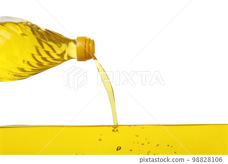 Pouring cooking oil from bottle on white background Pouring cooking oil from bottle on white background 98828106