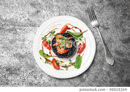 Delicious black risotto with seafood on grey table, flat lay 98828164