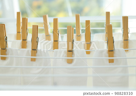 White socks hanging and drying on drying rack White socks hanging and drying on drying rack 98828310