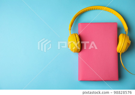 Book and headphones on light blue background, flat lay. Space for text Book and headphones on light blue background, flat lay. Space for text 98828576