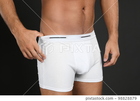Man in underwear on black background, closeup Man in underwear on black background, closeup 98828879