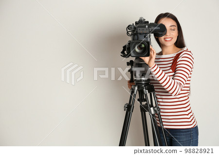Operator with professional video camera on white background, space for text 98828921