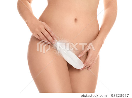 Woman with feather showing smooth skin on white background, closeup. Brazilian bikini epilation Woman with feather showing smooth skin on white background, closeup. Brazilian bikini epilation 98828927