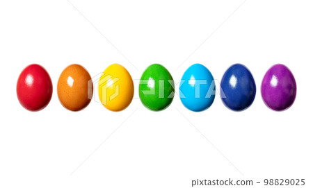 Rainbow, made of colorful dyed eggs, in a row. Hard boiled, multi colored chicken eggs, traditionally used during Easter time, as a gift, or for decoration. Front view close-up, isolated, macro photo. Rainbow, made of colorful dyed eggs, in a row. Hard boiled, multi colored chicken eggs, traditionally used during Easter time, as a gift, or for decoration. Front view close-up, isolated, macro photo. 98829025