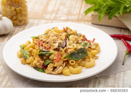 Stir-fried elbow macaroni with ground chicken in white plate,Pad Kra Pao,Thai fusion food Stir-fried elbow macaroni with ground chicken in white plate,Pad Kra Pao,Thai fusion food 98830363