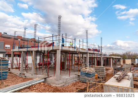 Construction site with steel formworks and reinforcing bars for pillars ready for concrete 98831025