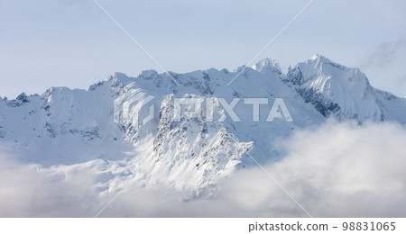 Tantalus Range covered in Snow and Clouds during Winter Season. 98831065