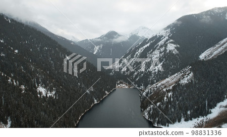 Kolsai mountain lake in the winter forest. 98831336